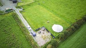 eine Luftaufnahme eines Feldes mit einem Zelt und Autos in der Unterkunft Unit 1 - Dolly Daydream Bell Tent in Carlisle + 2 Fotos