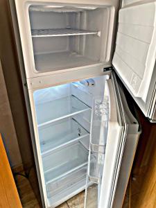 una nevera abierta con la puerta abierta y su en Cozy studio in Martianez, en Puerto de la Cruz 40 fotos más