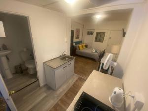 a bathroom with a sink and a toilet in a room at Home Estudio 3 in Santiago +2 photos