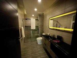 a bathroom with a shower and a toilet and a sink at Elysium in Islamabad