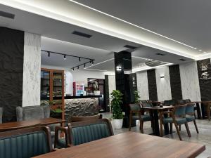 a dining room with wooden tables and chairs at Hotel Exclusive in Tirana