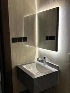 a bathroom with a sink and a mirror at شقة غرفة وصاله - حي البرج in Al Kharj