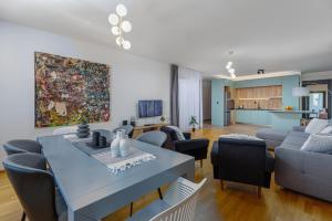 a living room with a table and chairs and a couch at Adriatic Masterpiece Residence in Sveti Stefan +20 photos