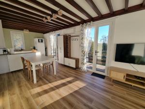 a kitchen and dining room with a table and a tv at Chalet in Journans