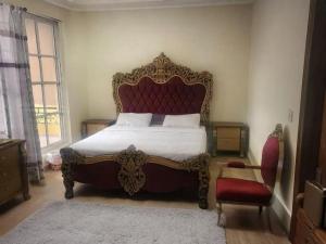a bedroom with a large bed and a chair at Paris High Muree Bhurban in Bhurban +18 photos