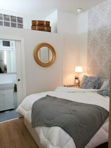 a bedroom with a large bed and a mirror at Loft Nórdico Madrid Aguilafuente in Madrid +13 photos