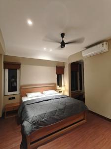 a bedroom with a bed and a ceiling fan at Evara - stay explore belong in Varanasi