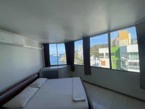 a bed in a room with a view of a city at Alojamientovacacional657 in Rodadero