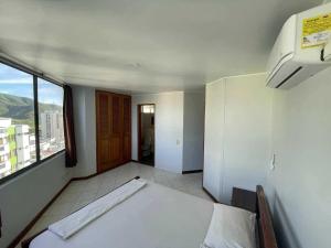 a small room with a bed and a window at Alojamientovacacional657 in Rodadero