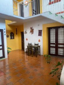 a dining room with a table and a balcony at Casa Bonita Centro in Oaxaca City
