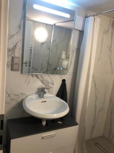 a bathroom with a sink and a mirror at Chambrette bei Kassel in Eiterhagen +6 photos