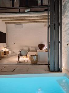 a living room with a couch and a pool at Casa do Capitão in Monte Trigo +33 photos