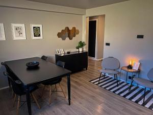 a living room with a table and two chairs at Urban Oasis in Keflavík