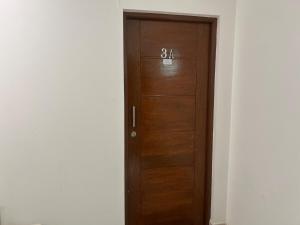 a wooden door with numbers on it in a room at Departamento independiente in Sucre