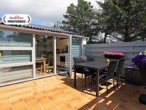 a patio with a table and chairs on a deck at 2 person holiday home in Vejers Strand-By Traum in Vejers Strand