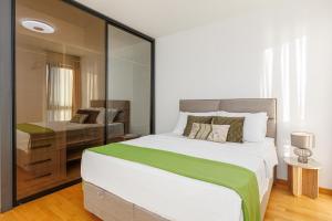 a bedroom with a large bed and a desk at Adriatic Masterpiece Residence in Sveti Stefan