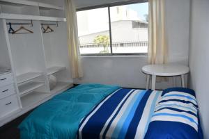 a small bedroom with a bed and a window at B&B Villamar Chorrillos in San Antonio +27 photos