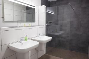 a white bathroom with a sink and a mirror at Pension Dalinghaus in Vörden +53 photos