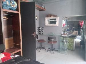 a kitchen with a counter and two stools in a room at Loft central in Pelotas
