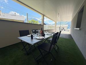 a table and chairs in a room with a view at Appartement Le Cosy Proche Station Ski - Piscine in Saint Avre la Chambre +37 photos
