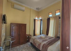 Ένα ή περισσότερα κρεβάτια σε δωμάτιο στο FIFAWIND HOTEL