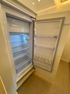 an empty refrigerator with its door open in a kitchen at Luxury 1 Bedroom Apartment with Sofa Bed & Balconies Prime Location near ING Arena, Expo 12 & Atomium in Wemmel