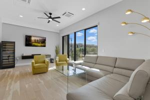 a living room with a couch and two yellow chairs at Scottsdale - 1501 N Miller Rd #1015 in Scottsdale
