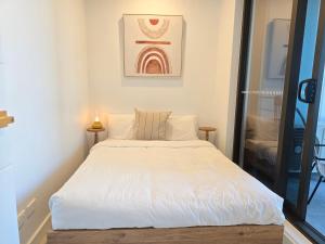 a bedroom with a large bed with white sheets at Paramount Suite on Parkes Pool And City View in Sydney +6 photos