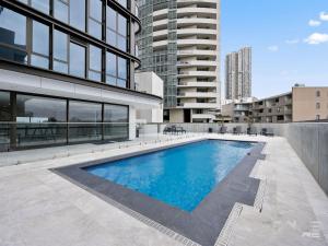 a swimming pool in the middle of a building at Paramount Suite on Parkes Pool And City View in Sydney