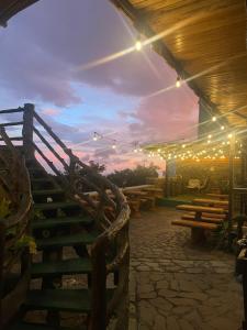a lit up patio with wooden benches and lights at Cabinas Vista Al Golfo in Monteverde Costa Rica