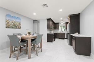 a kitchen and dining room with a table and chairs at 5 Min to Sanibel 10 Min to FM Beach 4BR Oasis in Fort Myers