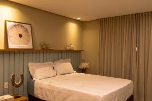 a bedroom with a bed and a shelf above it at Casa Varandas Morro de São Paulo in Cayru