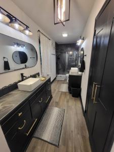 a bathroom with a sink and a toilet and a tub at Exquisite, newly renovated large home near I-85 in Kannapolis