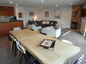 a living room with a table and a couch at The Peak 202 in Mount Buller