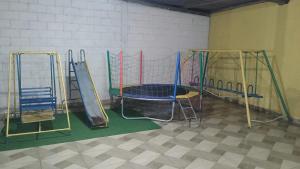 a gym with three slides and a trampoline at Sítio vida boa - Jambreiro in Itabira