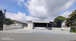 a white building with a bike parked in front of it at 8ight Guesthouse 8号民宿 in Kluang