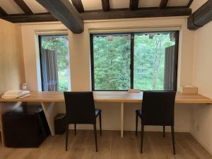 a large wooden table with chairs in front of a window at Shimosato - Vacation STAY 77681v in Komatsu