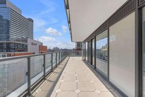 a balcony of a building with a view of a city at Prime 2BR Condo with Massive Patio & Parking in Toronto