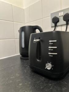 a black toaster sitting on top of a counter at Luxury Apartment in Milton Keynes with Netflix in Broughton