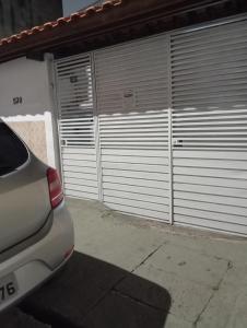 a car parked in front of two garage doors at Hostel Brasil Gru in Guarulhos