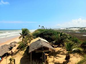 a hut on the beach next to the ocean at QUARTO PRIVATIVO - RECANTO dos SONHOS - MASSARANDUPIÓ in Massarandupio