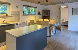 a kitchen with a counter and a dining room at 2 Bedroom Cozy Home In Ebeltoft in Øksenmølle