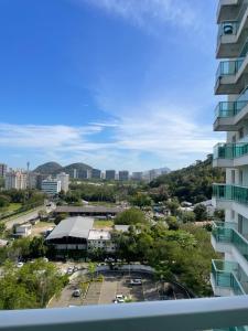 a view of the city from the balcony of a building at Apartamento completo ao lado do Riocentro - Rock in Farmasi Arena, Parque Olímpico in Rio de Janeiro