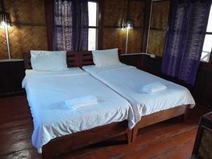 Ένα ή περισσότερα κρεβάτια σε δωμάτιο στο Sainamhai Resort