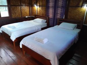 Ένα ή περισσότερα κρεβάτια σε δωμάτιο στο Sainamhai Resort