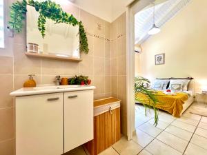 a kitchen with a sink and a bed in a room at Kaz a Doudou La in Saint-François