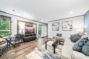 a living room with a couch and a table at Bon Air Bungalow in Sparta