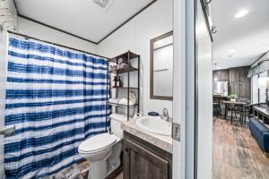 a bathroom with a toilet and a sink at Bon Air Bungalow in Sparta +16 photos