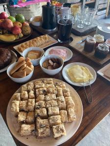 a table topped with plates of food and desserts at Casa da Praia in São José do Norte