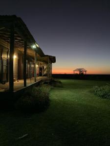 a building with a view of a field at night at Casa da Praia in São José do Norte +9 photos